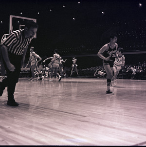 Basketball players and referee at NC State versus University of Florida game, circa 1969