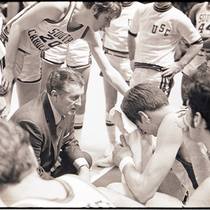 Basketball coach and players at NC State versus University of South Carolina game, circa 1969
