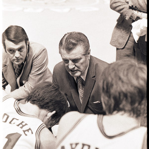 Basketball coaches and players at NC State versus University of South Carolina game, circa 1969