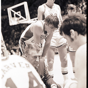 Basketball coach and players at NC State versus University of South Carolina game, circa 1969