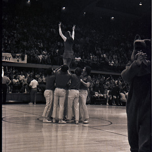 Cheerleaders and mascot at NC State versus University of South Carolina basketball game, 1970 or 1971