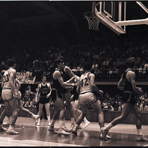 Basketball players feat. Dan Wells and referee at NC State vs. Virginia game, circa 1969-1975