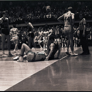 Basketball players feat. Bob Heuts, Rick Holdt and referee at NC State vs. Virginia game, circa 1969-1975