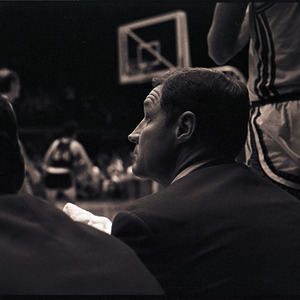 Basketball coaches and player at NC State versus Virginia game, circa 1969-1975