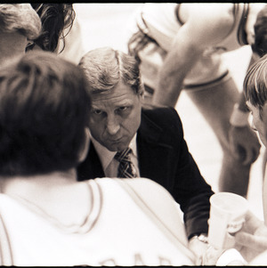 Basketball coach and players at NC State versus Virginia game, circa 1972-1975