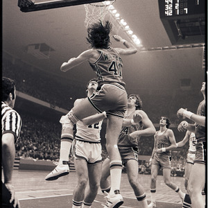 Basketball players and referee at NC State versus Virginia game, circa 1972-1975