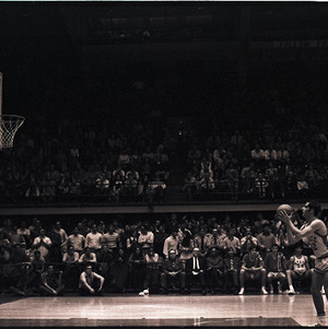 Basketball player and referee at NC State versus Virginia Tech game, 1970
