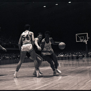 Basketball players and referee at NC State versus Virginia Tech game, 1970