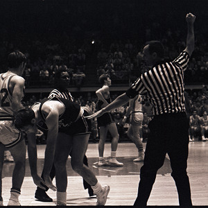 Basketball players and referees at NC State versus Virginia Tech game, circa 1969-1975