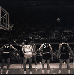 Basketball players and referee at NC State versus Virginia Tech game, circa 1969-1975
