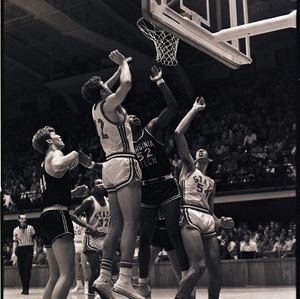 Basketball players and referee at NC State versus Virginia Tech game, circa 1969-1975