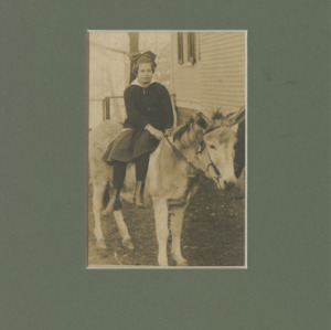 Young Mary E. Yarbrough seated on a donkey or mule