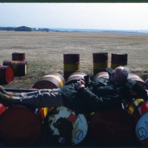 Resting on barrels, Port Montreuil, Prince Edward's Island, April 1981