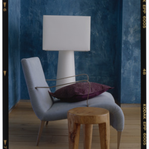Blue chair with brown bag and white lamp, Tricia Guild interior design