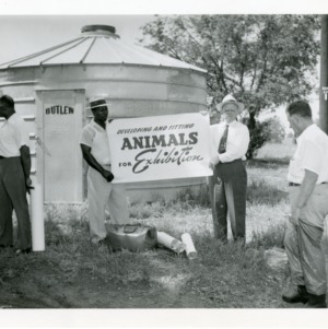 Group with sign "Developing and Fitting Animals for Exhibition"