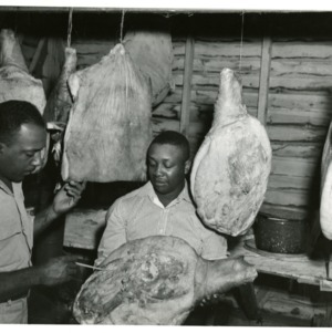 Photo of Men Processing Meat