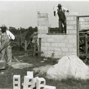 Photo of Men Laying Bricks