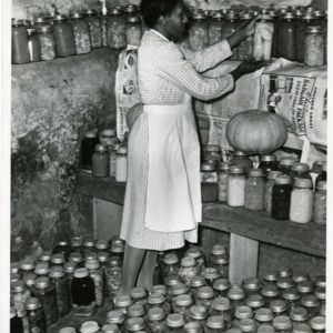 Photo of A Woman Placing with Squash in a Jar