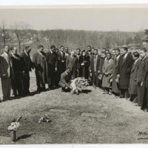 Photograph of S.B. Simmons, standing fourth from the left side of the picture with a group of people at a graveside