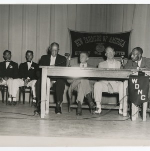 A Photograph of an Unidentified Man Speaking Under the Banner of the Durham Chapter of the NFA