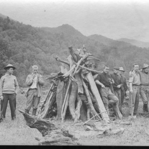 Group of Men With a Pile of Wood