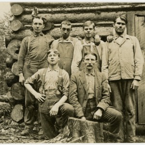 Group of Men and Cabin