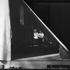 Two people inside a tent