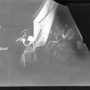 Mrs. Adele Schenck and two other woman outside tent