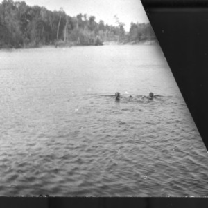 Two people swimming in lake