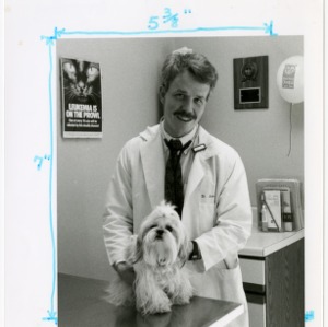 A veterinarian and a fluffy dog in exam room