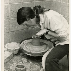 Woman working at potter's wheel