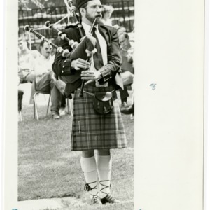 Man playing the bagpipes at Open House
