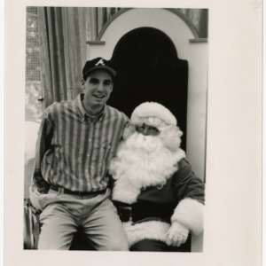 Student sits on Santa's lap at Crabtree Mall