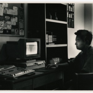 Student at a computer in the dark