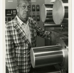 Dr. John Cuculo, textile researcher, stands near his laboratory equipment