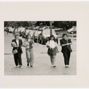 Four women walking down the street