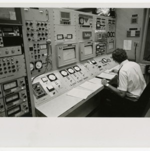 Man sits in Burlington reactor control room
