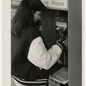 Student uses an off-campus pay phone to register for classes using TRACS