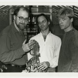 Three NCSU scientists demonstrating the results of their research on genetically engineering tobacco