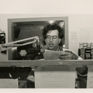 A student reads from cards at the WKNC microphone