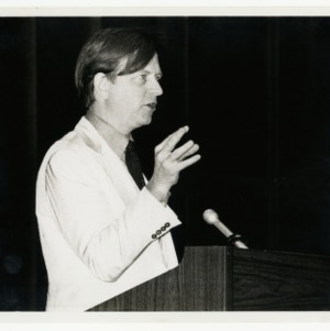 Tom Wolfe stands at podium