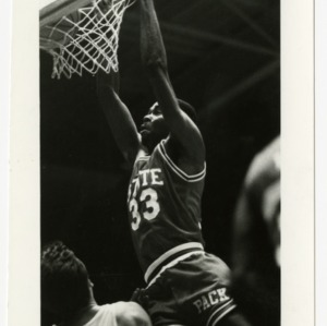 NC State basketball player number thirty-three hangs from the net