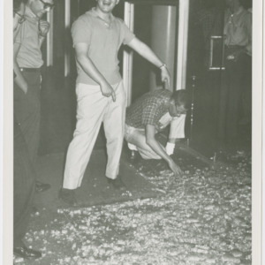 Student examining shattered front door