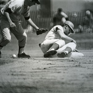 North Carolina State baseball player slides into base in a game against Wake Forest University