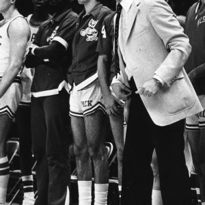 Coach Jim Valvano and basketball players at game
