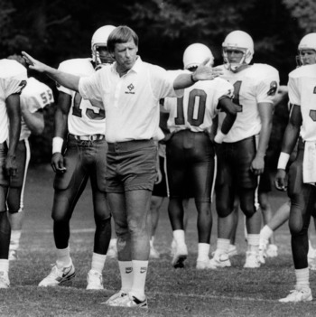Coach Dick Sherridan and football players during practice