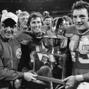 Lou Holtz, Pat Kenney, and Tom Siegfried with Peach Bowl championship trophy