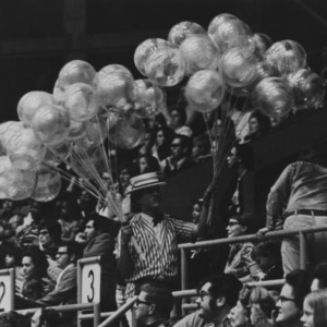Vendor selling balloons at sports game