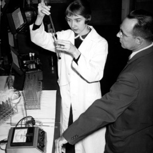 Mrs. Johnston and Professor W. P. Ingram in chemistry laboratory