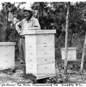 Beekeeper J. E. Dodson in apiary